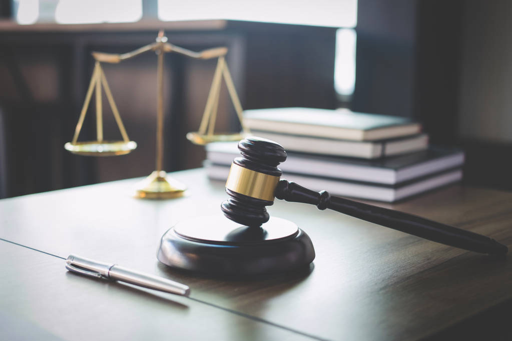 Scales of justice and Gavel on wooden table and Lawyer or Judge  - Photo, Image