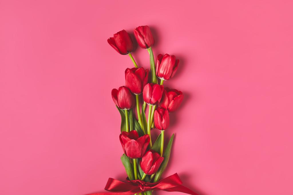 Widok z góry z czerwone tulipany, przewiązane wstążką na różowy, koncepcja dzień matki - Zdjęcie, obraz