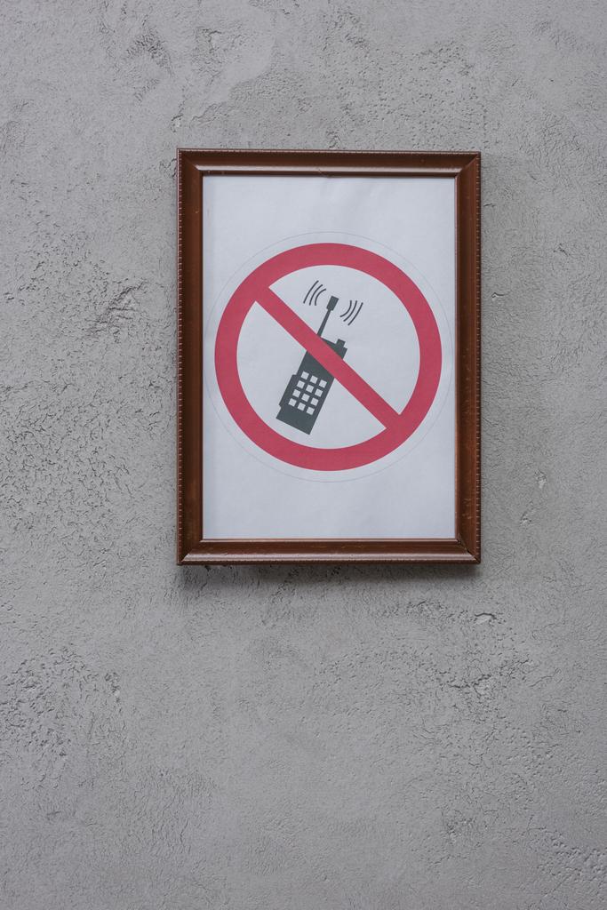 restricted phone placard on concrete wall - Photo, Image