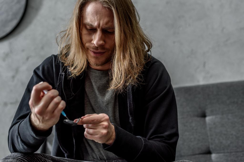 close-up shot of addicted junkie boiling heroin in spoon with lighter - Photo, Image