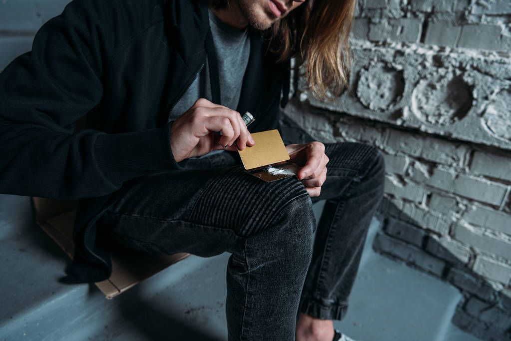 Schnappschuss von süchtigem Mann, der Kokain von Kreditkarte schnüffelt - Foto, Bild