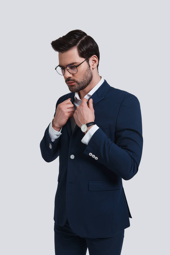 handsome young man in suit jacket adjusting collar  - Photo, Image