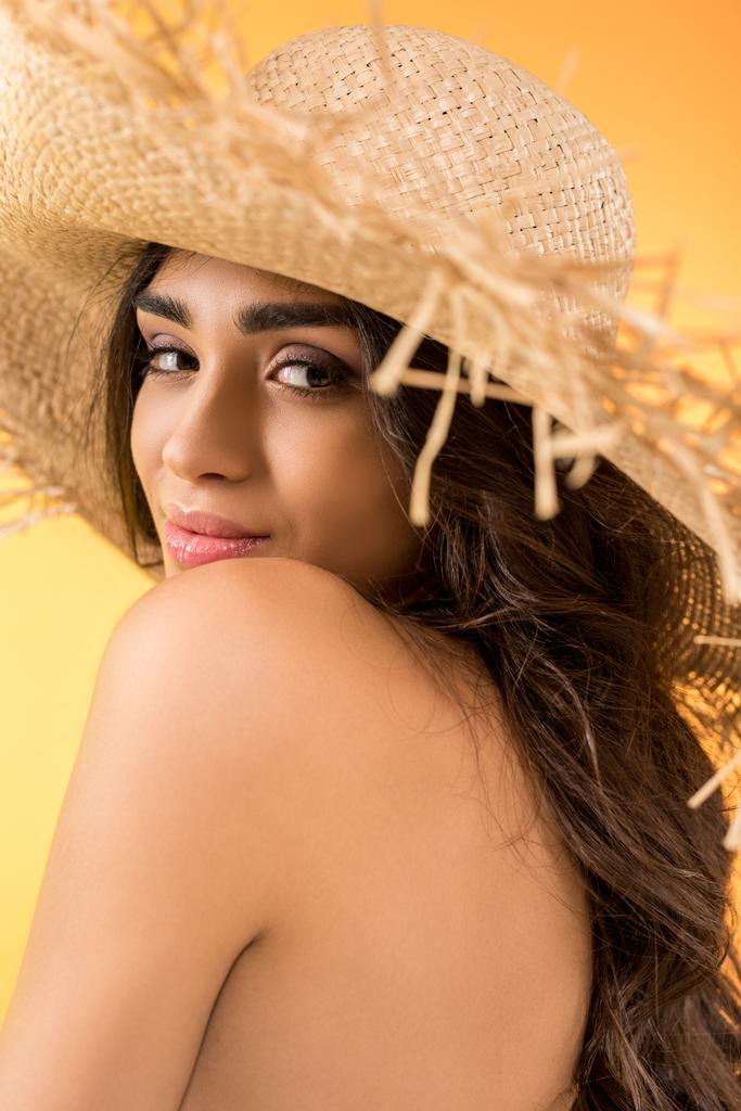 attractive girl posing in straw hat, isolated on yellow - Photo, Image
