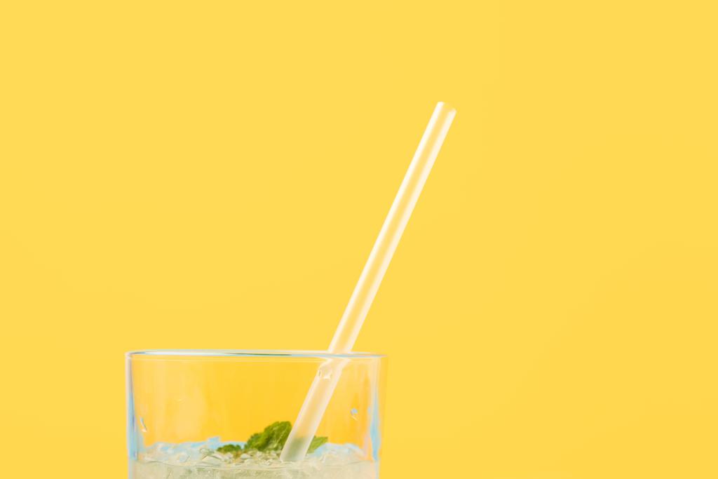 close-up view of glass with fresh cold summer cocktail and drinking straw isolated on yellow - Photo, Image