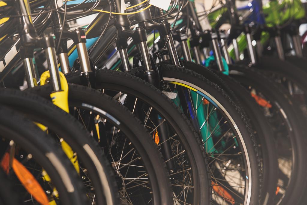 close-up view of wheels of bikes selling in bicycle shop - Photo, Image