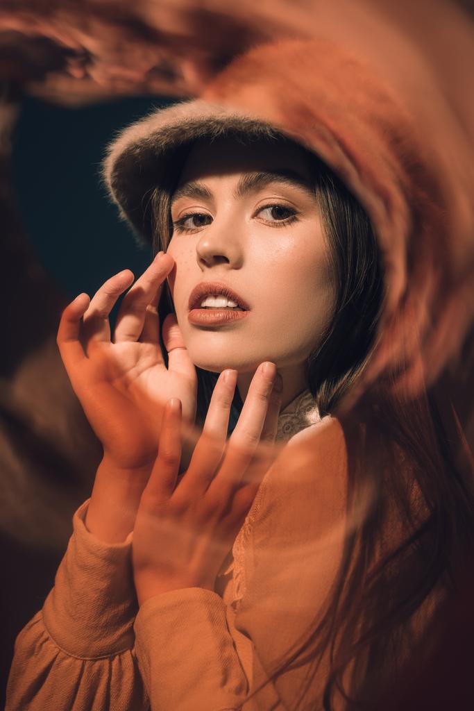 portrait of fashionable young woman in hat looking at camera - Photo, Image