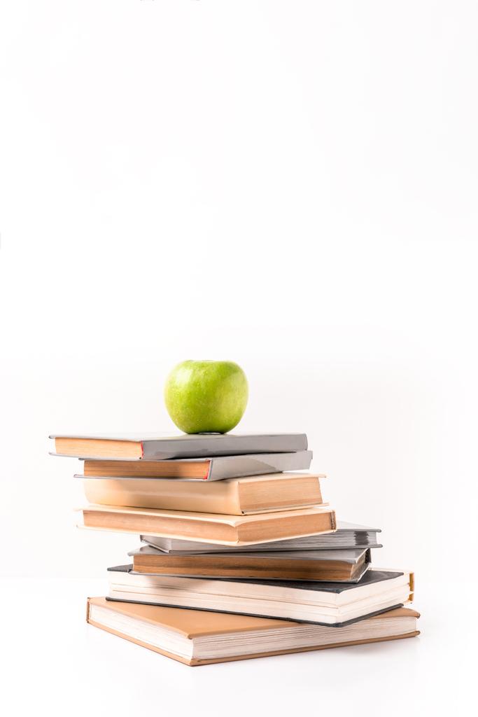 Apple on pile of books isolated on white - Photo, Image