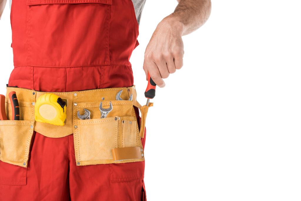 Close-up view of handyman taking tools in belt isolated on white - Photo, Image