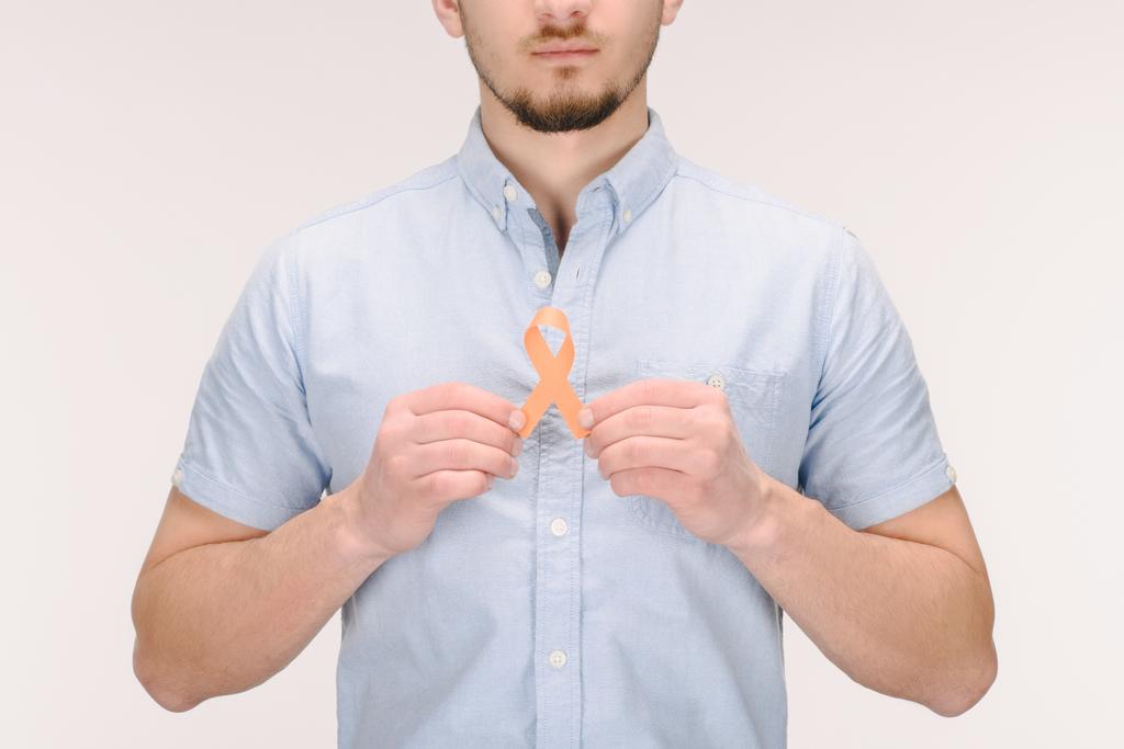 partial view of man with orange leukemia, kidney cancer, multiple sclerosis RSD awareness ribbon isolated on white - Photo, Image