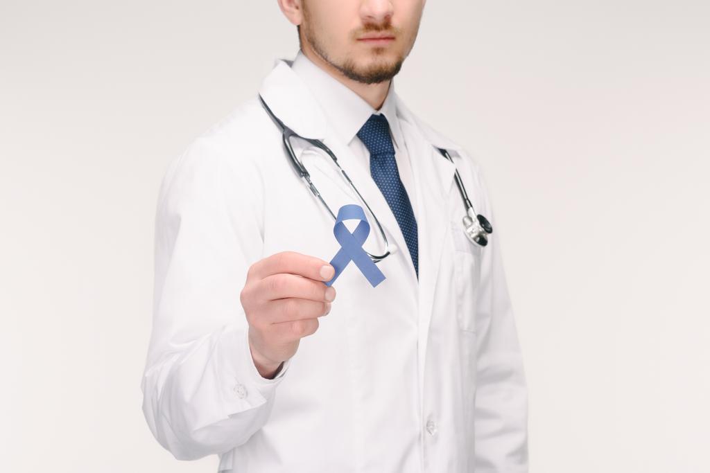cropped shot of doctor with stethoscope showing blue ribbon isolated on white, prostate cancer concept - Photo, Image