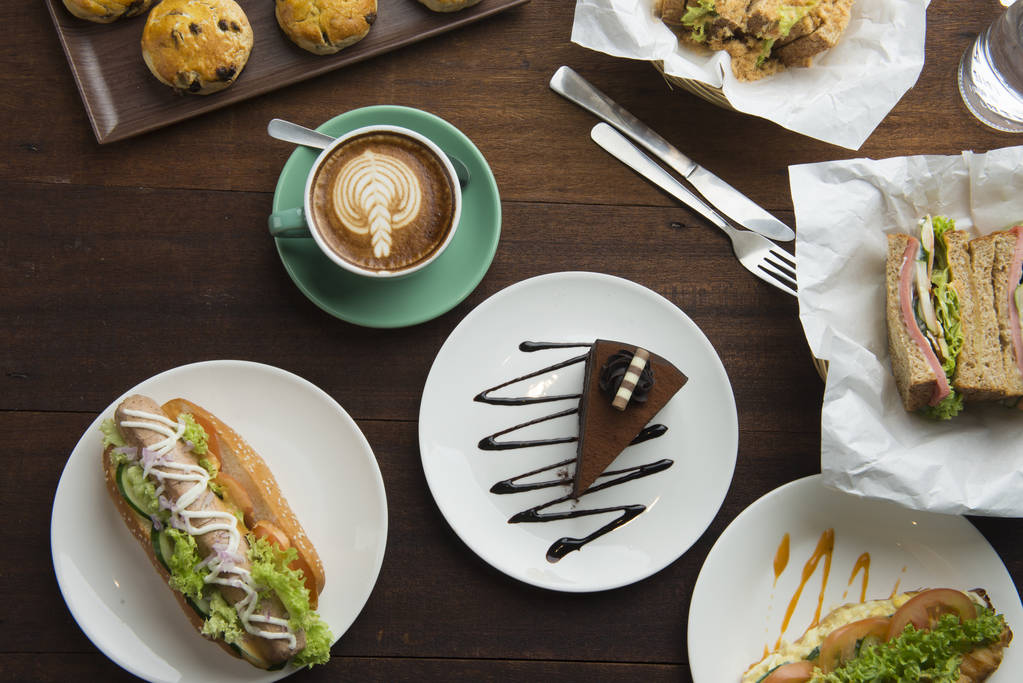 Different types of coffee and food on dark table, top view - Photo, Image