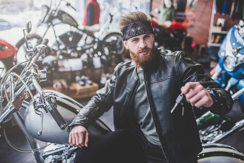 Чоловік в магазині мотоциклів
 - Фото, зображення