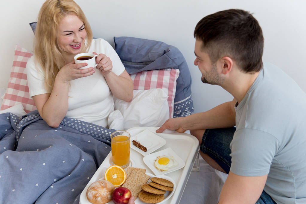 Пара насолоджується сніданком у ліжку
 - Фото, зображення