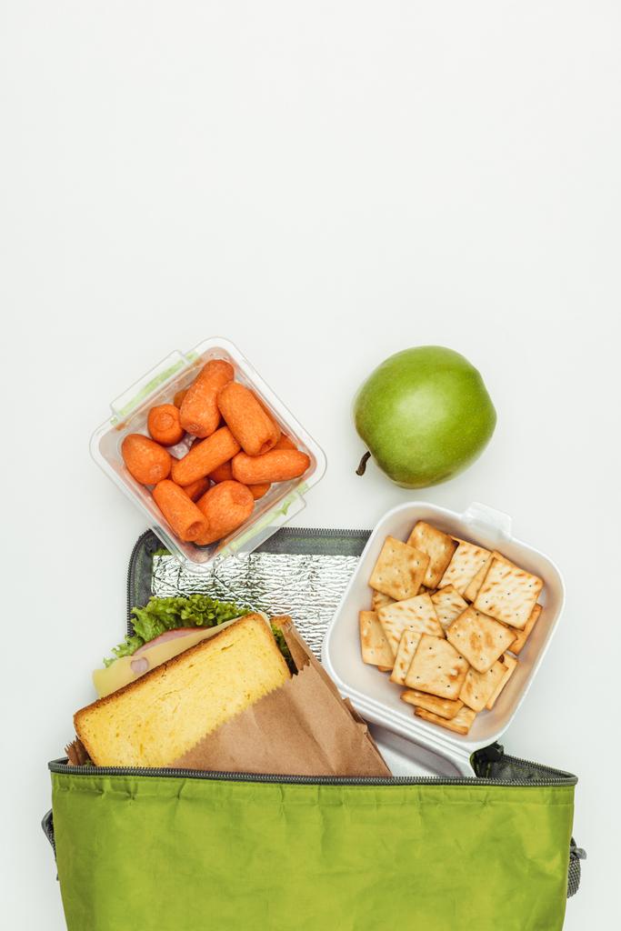 vista superior de sanduíche e cenouras com maçã em saco de almoço isolado em branco
 - Foto, Imagem