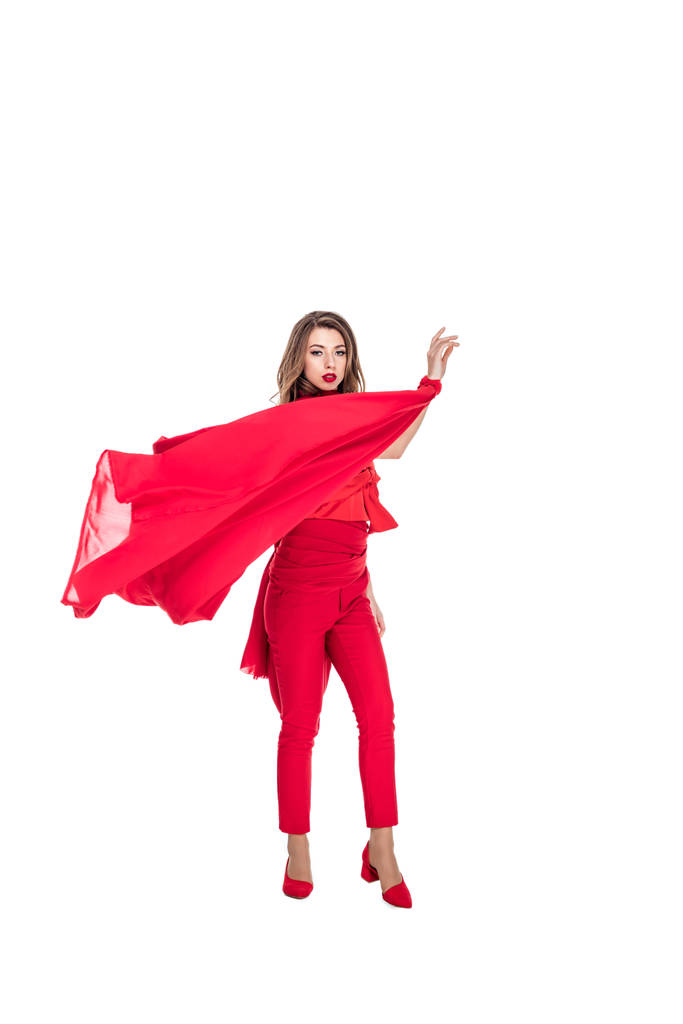 елегантна жінка позує в червоному одязі, ізольована на білому
 - Фото, зображення