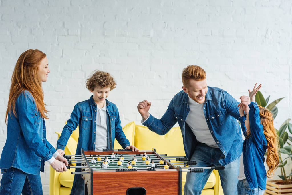 Children and parents playing table football together - Photo, Image