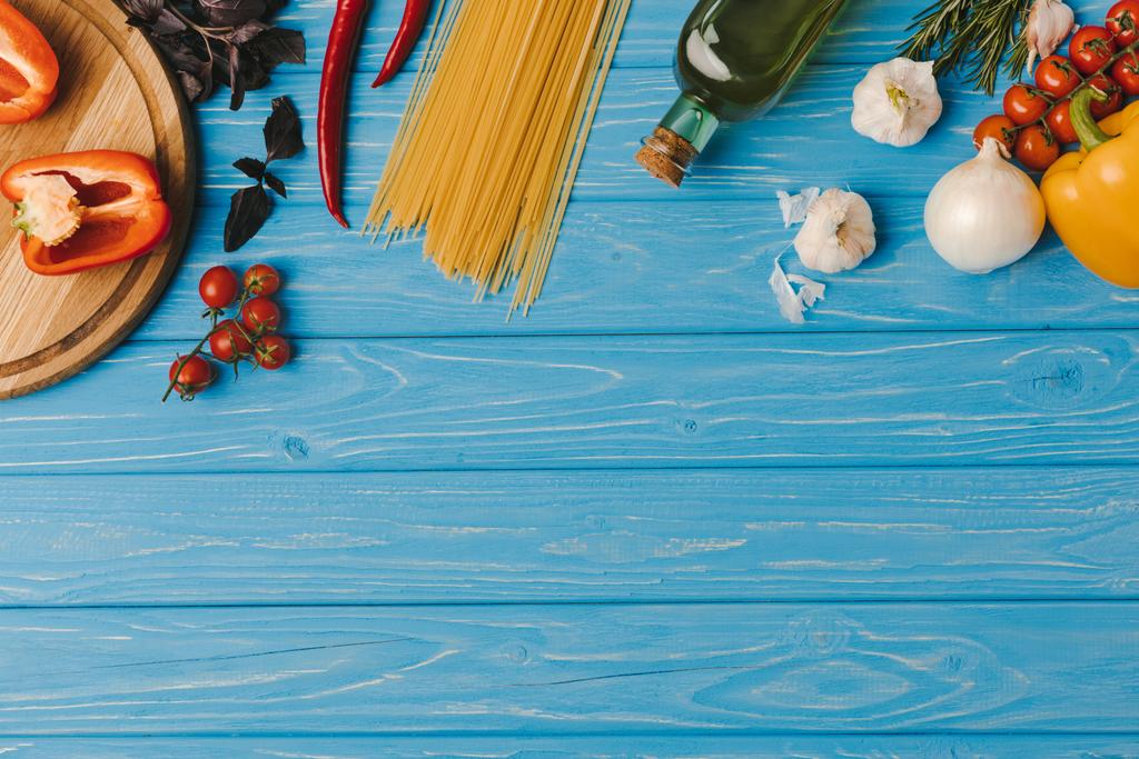 top view of ingredients for cooking pasta on blue surface - Photo, Image