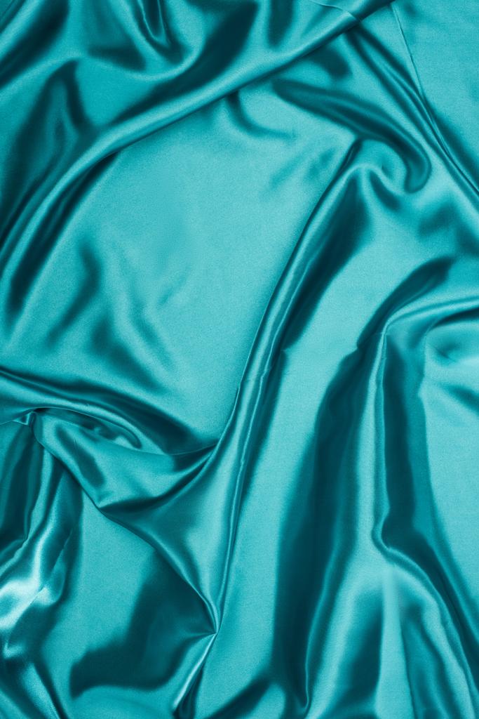 бірюзовий блискучий хвилястий атласний тканинний фон
 - Фото, зображення