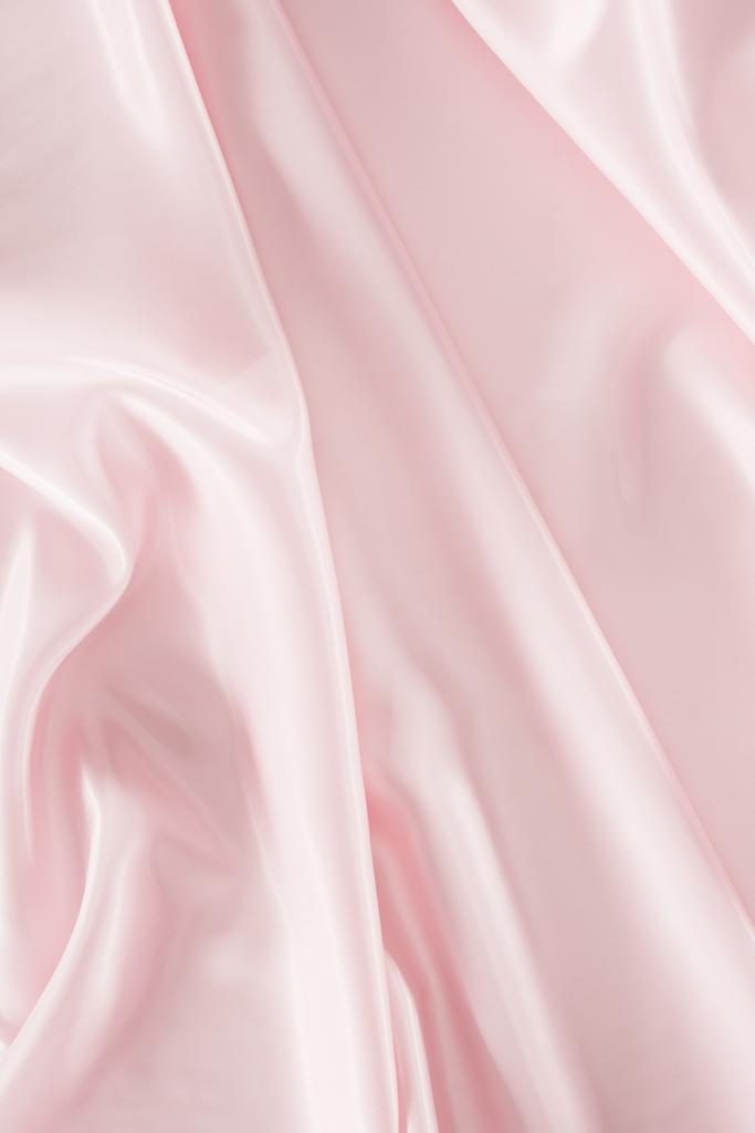 ελαφρύ ροζ γυαλιστερό ύφασμα σατέν φόντο - Φωτογραφία, εικόνα