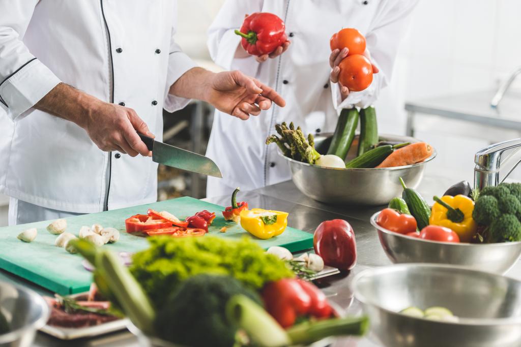 cropped image of chefs preparing vegetables at restaurant kitchen - Photo, Image