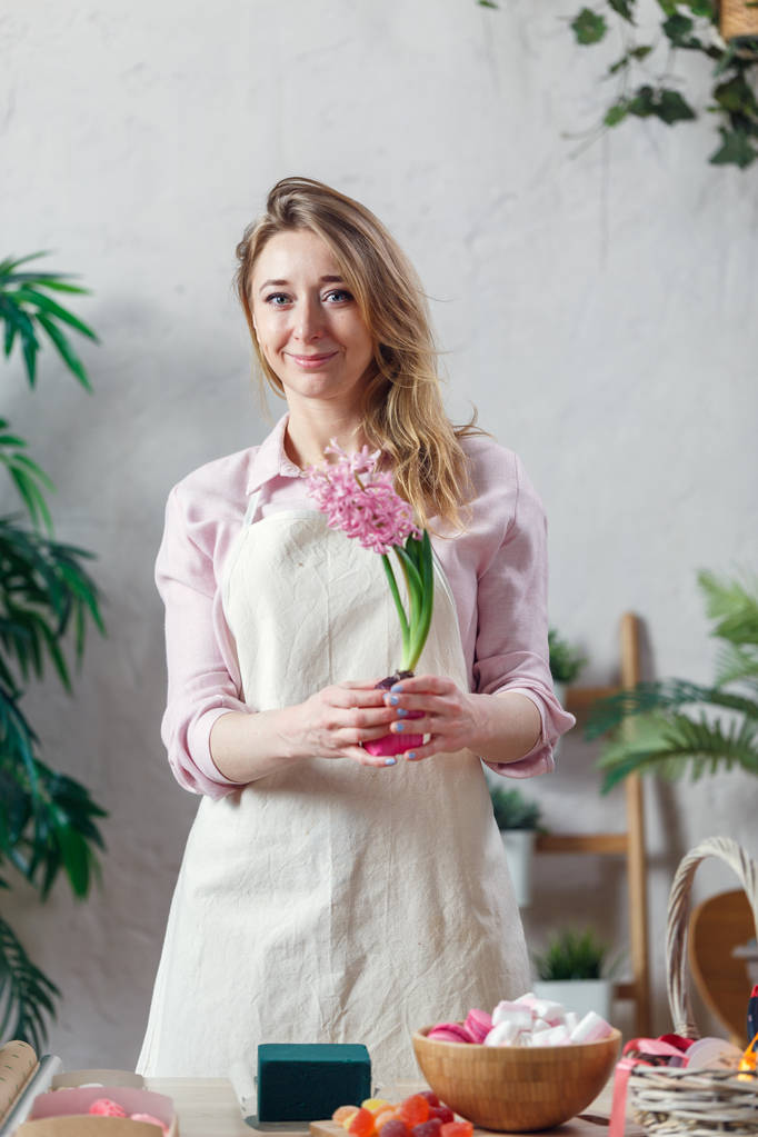 Portrait of florist woman in apron at room with flowers - Photo, Image