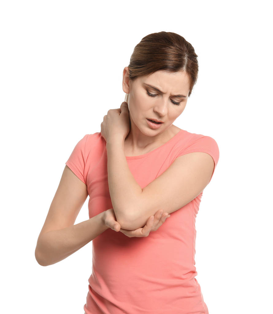junge Frau leidet unter Ellbogenschmerzen auf weißem Hintergrund - Foto, Bild