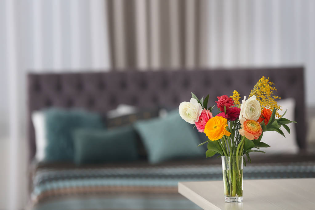 Vaso com belas flores de ranúnculo na mesa dentro de casa
 - Foto, Imagem