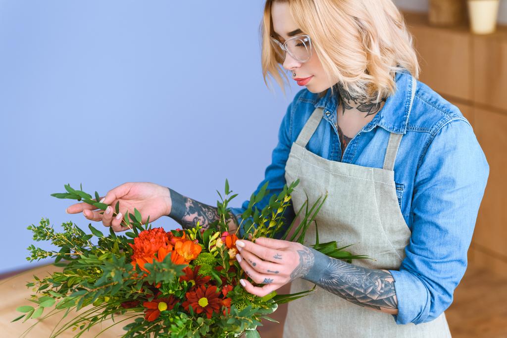 bela jovem florista em óculos organizando buquê de flores
 - Foto, Imagem