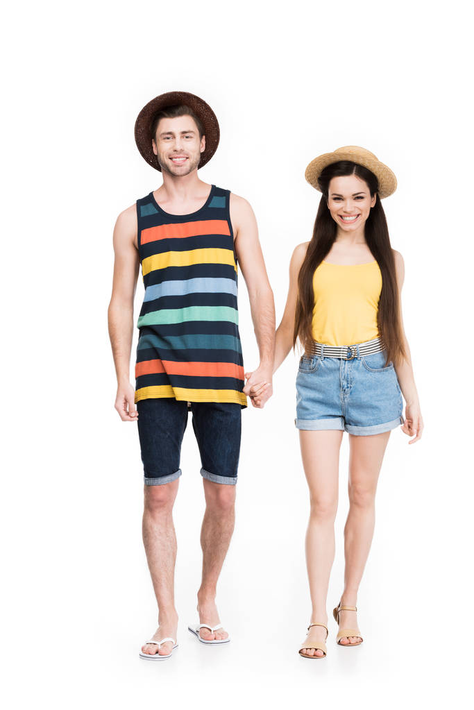 веселая пара в солнечных очках и шляпах, держась за руки, изолированные на белом
 - Фото, изображение