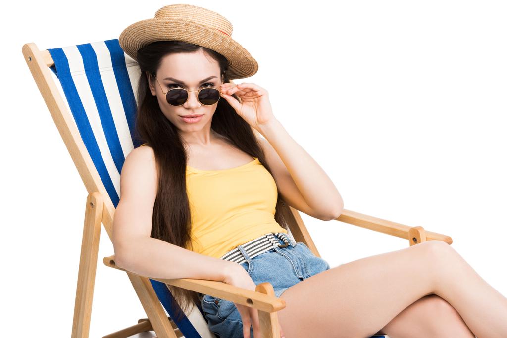 beautiful girl in sunglasses relaxing on beach chair, isolated on white - Photo, Image
