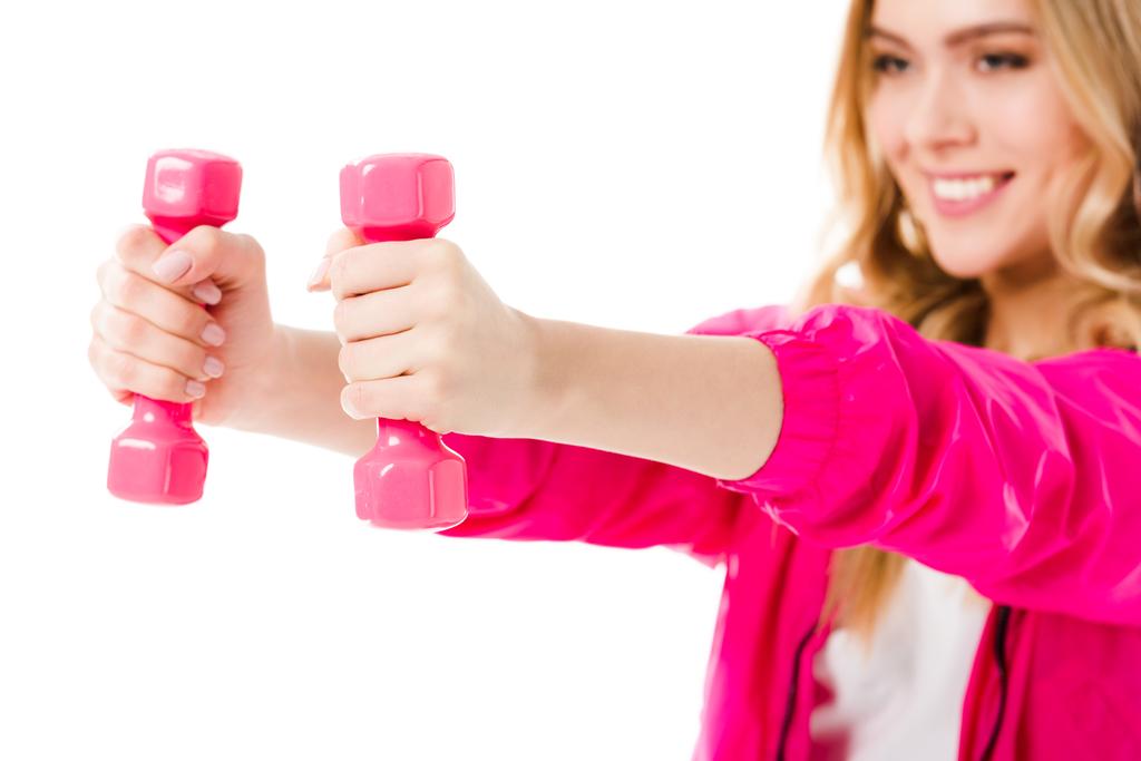 Pink dumbbells in hands of young girl isolated on white - Photo, Image