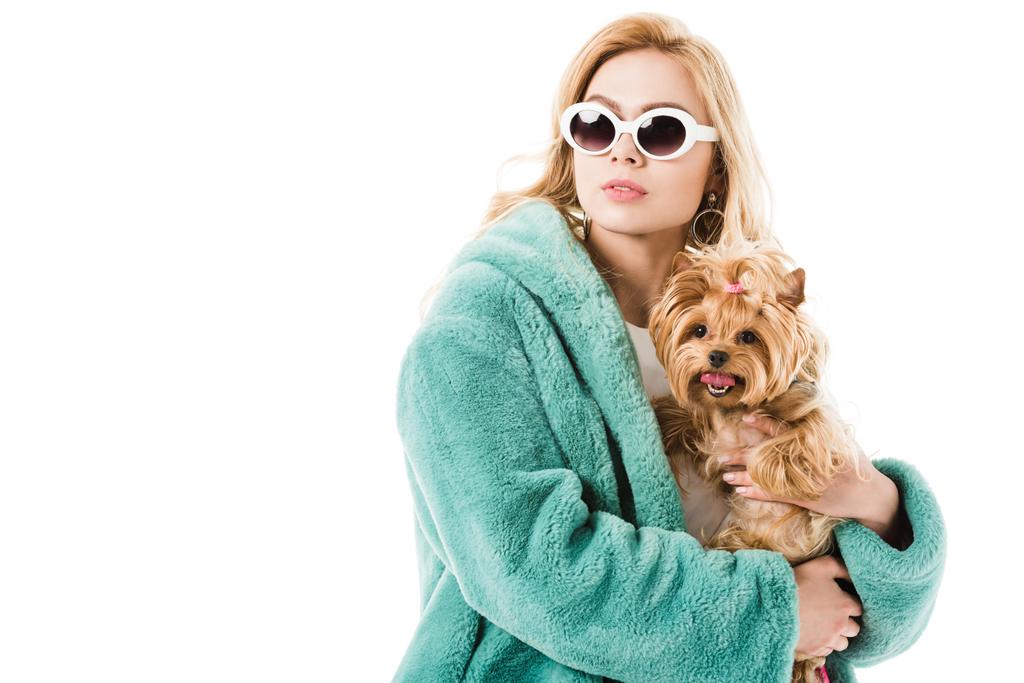 Blonde woman wearing fur coat holding cute dog isolated on white - Photo, Image