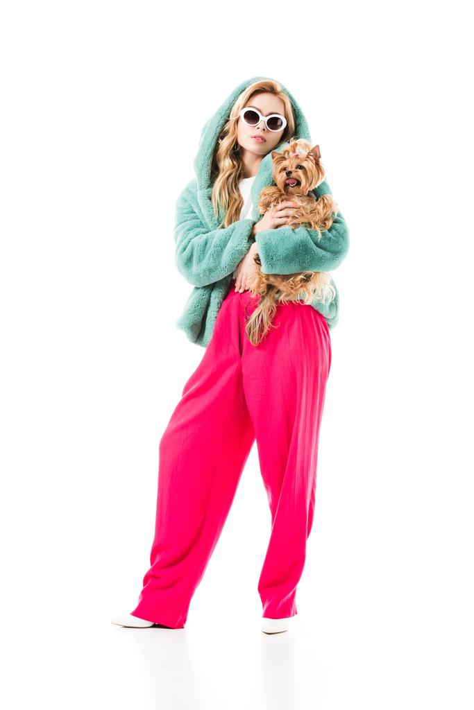 Blonde woman in fur coat holding cute Yorkie isolated on white - Photo, Image