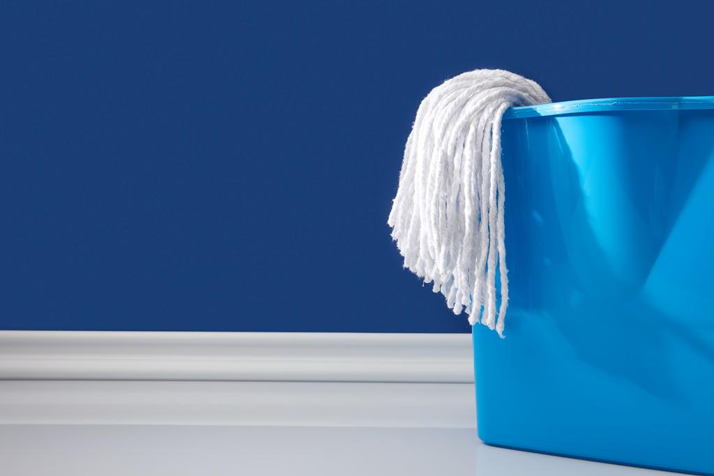 rag and bucket for spring cleaning on blue - Photo, Image