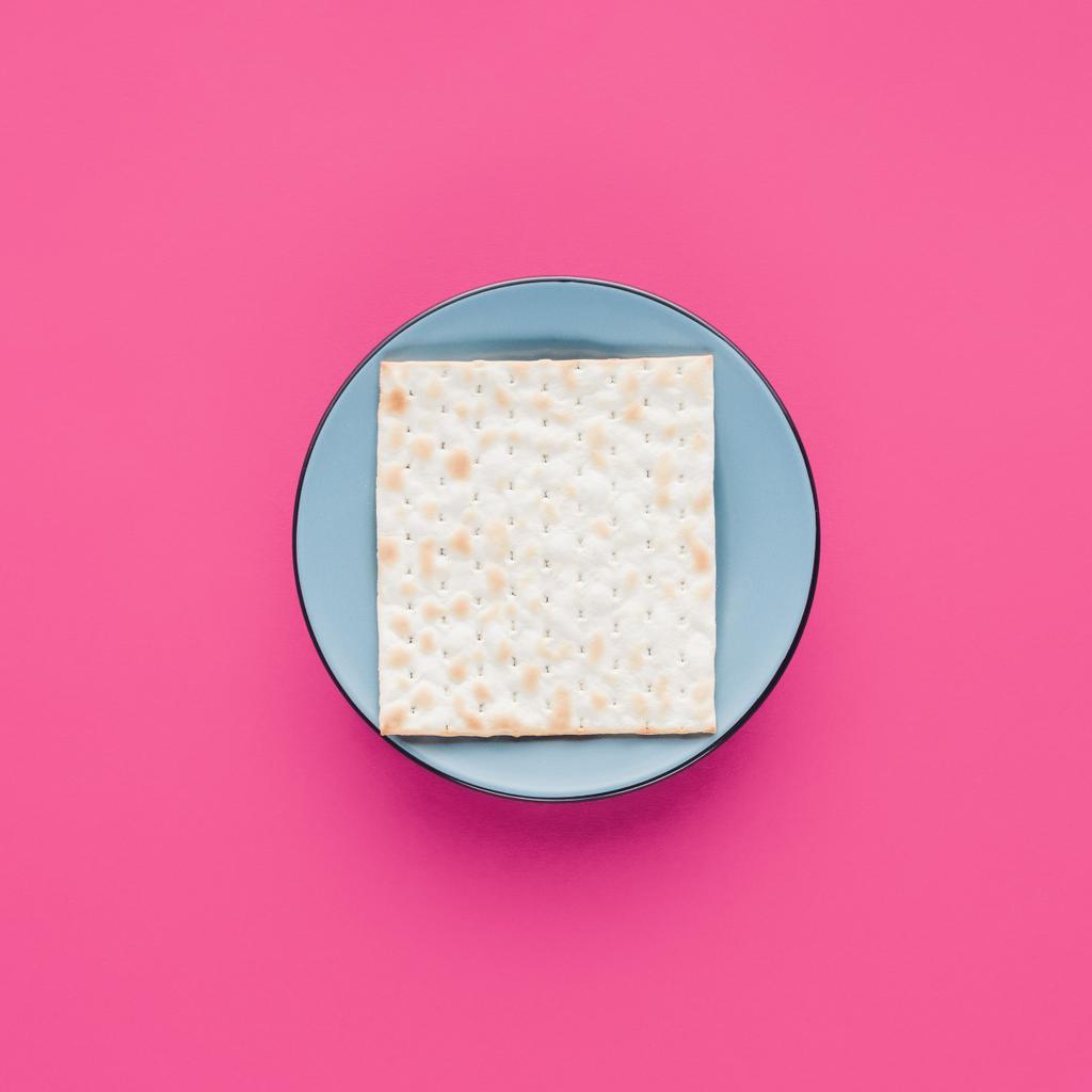 top view of plate with matza isolated on pink, Passover Tale concept - Photo, Image
