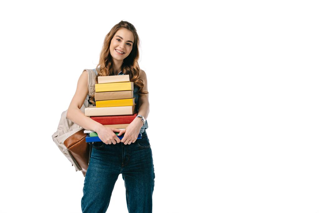 smiling beautiful student holding stack of books isolated on white - Photo, Image