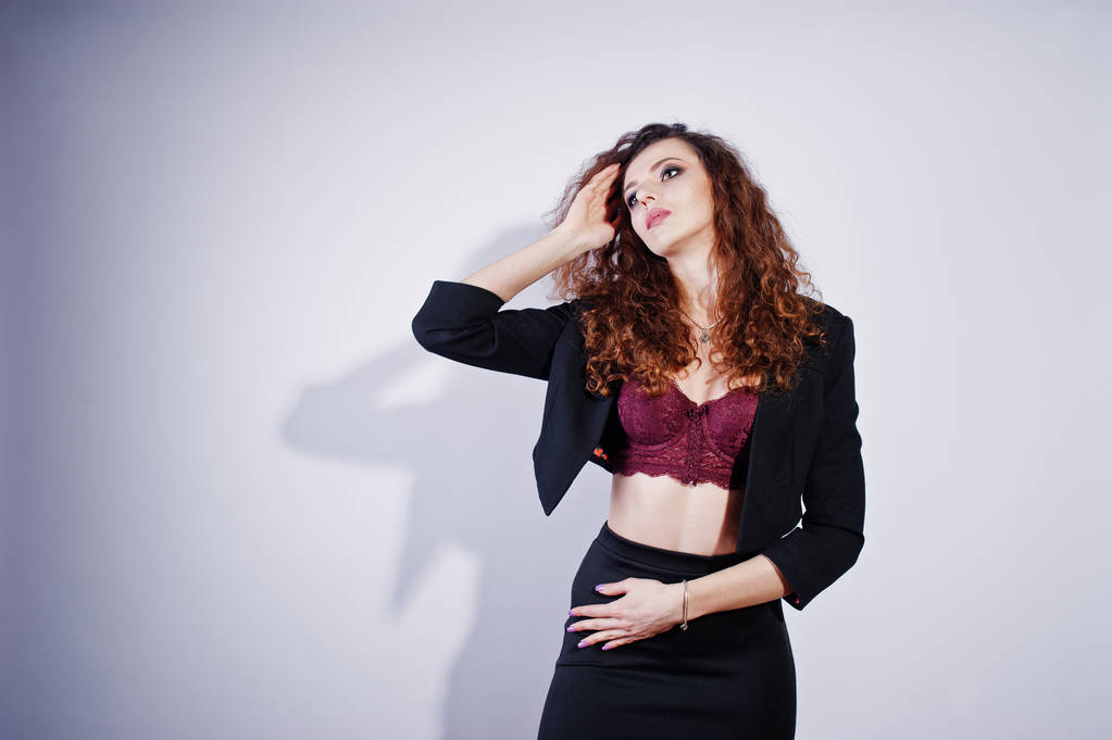 Brunette curly haired girl in black office jacket with skirt, on - Photo, Image