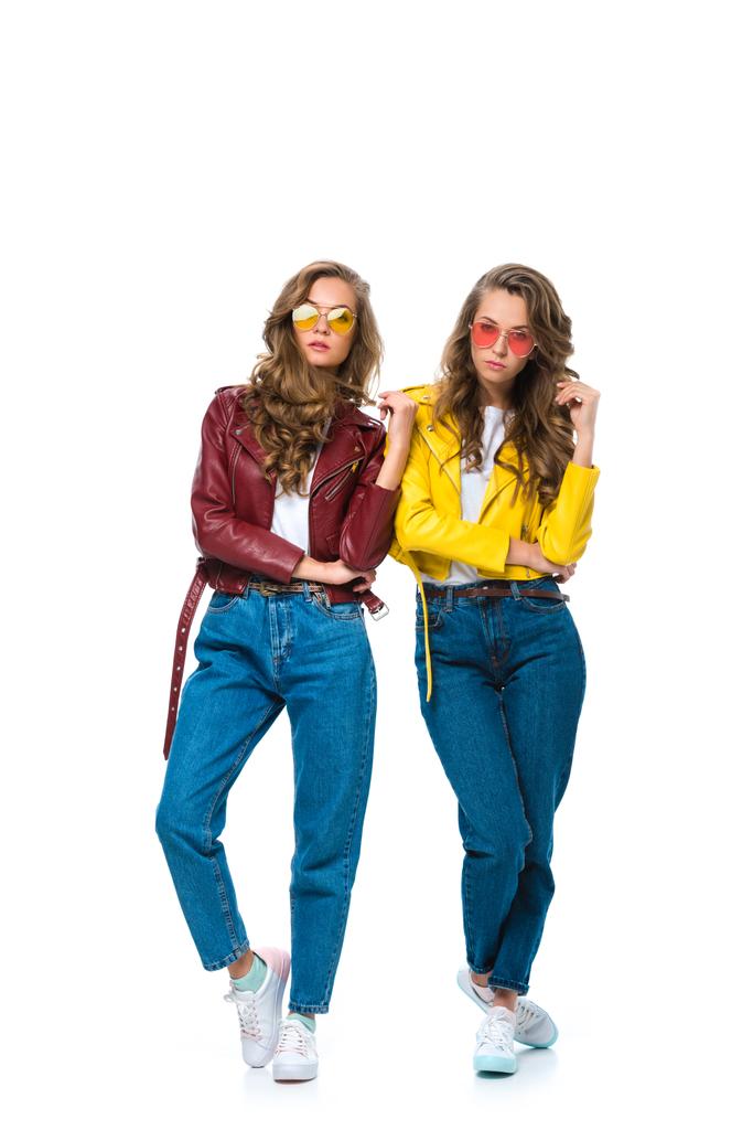 attractive stylish twins in leather jackets and sunglasses looking at camera isolated on white - Photo, Image