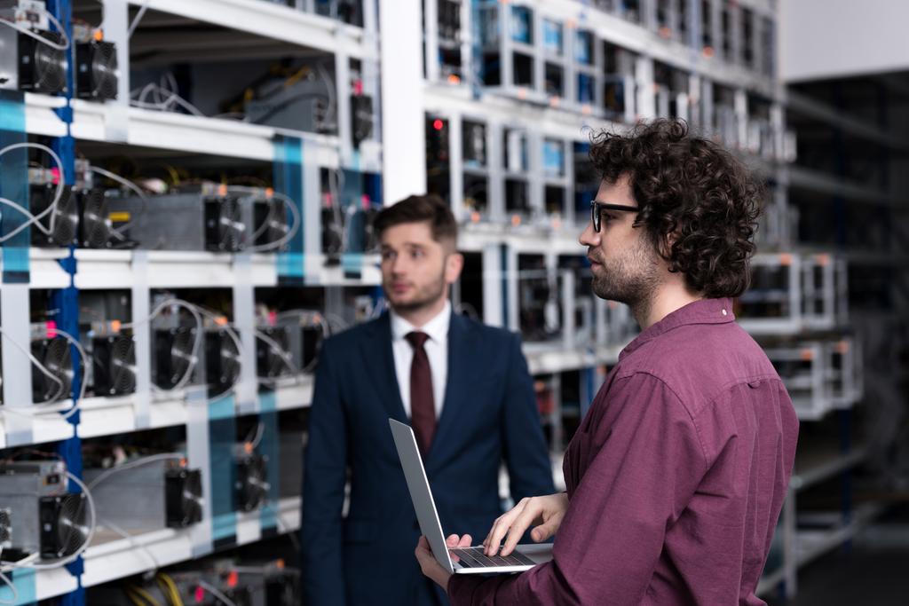 successful businessman and computer engineer working together at bitcoin mining farm - Photo, Image
