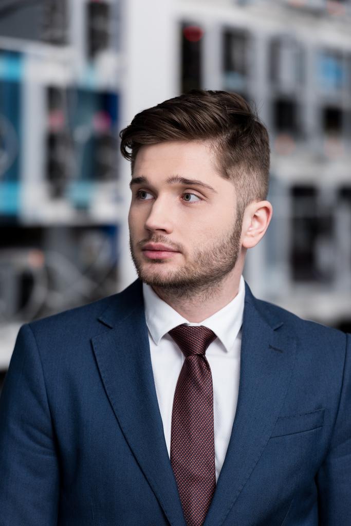 close-up portrait of handsome young businessman at cryptocurrency mining farm - Photo, Image