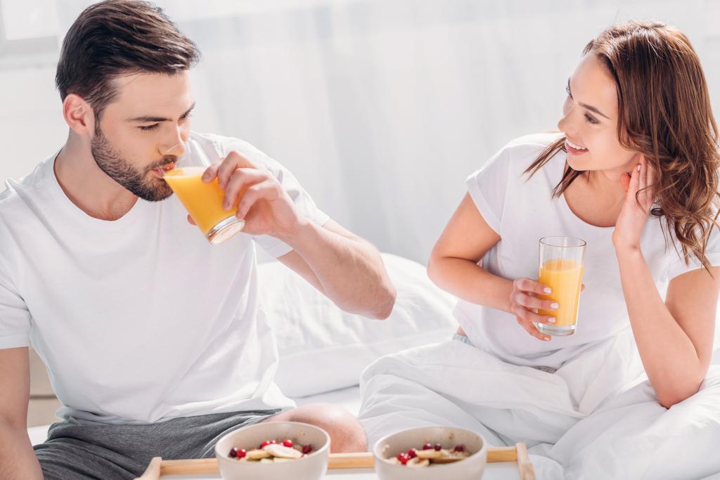 Genç çift yatakta sabah birlikte kahvaltı - Fotoğraf, Görsel