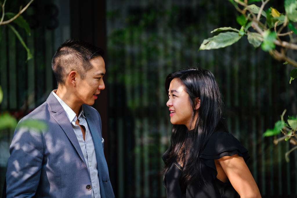 portrait of two professional business people walking and talking. They are deep in conversation as they walk on a street in a city in Asia. The man and woman are both professionally dressed. - Photo, Image