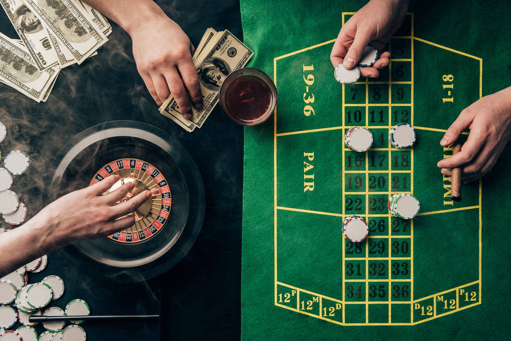 People placing bets while playing roulette on casino table - Photo, Image