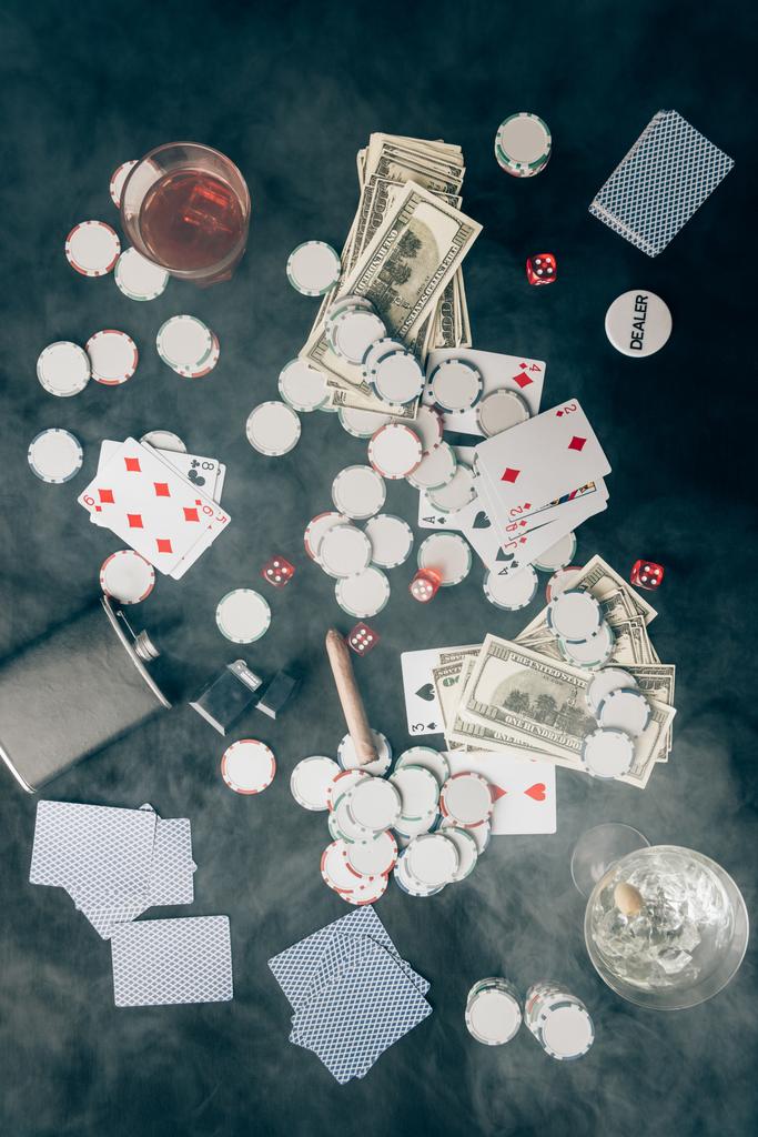 Smoke over chips and money on casino table - Photo, Image