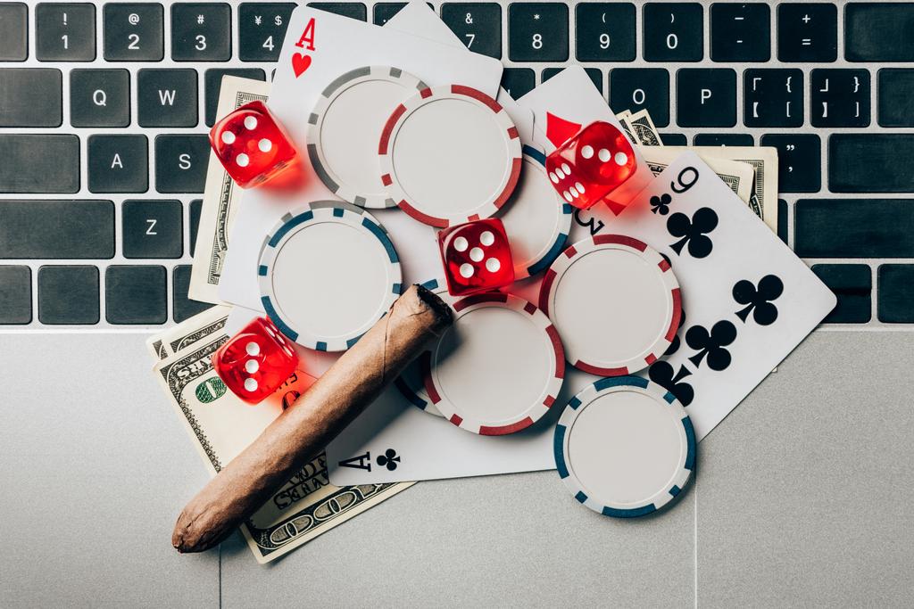 Online gambling concept with chips and money on laptop - Photo, Image