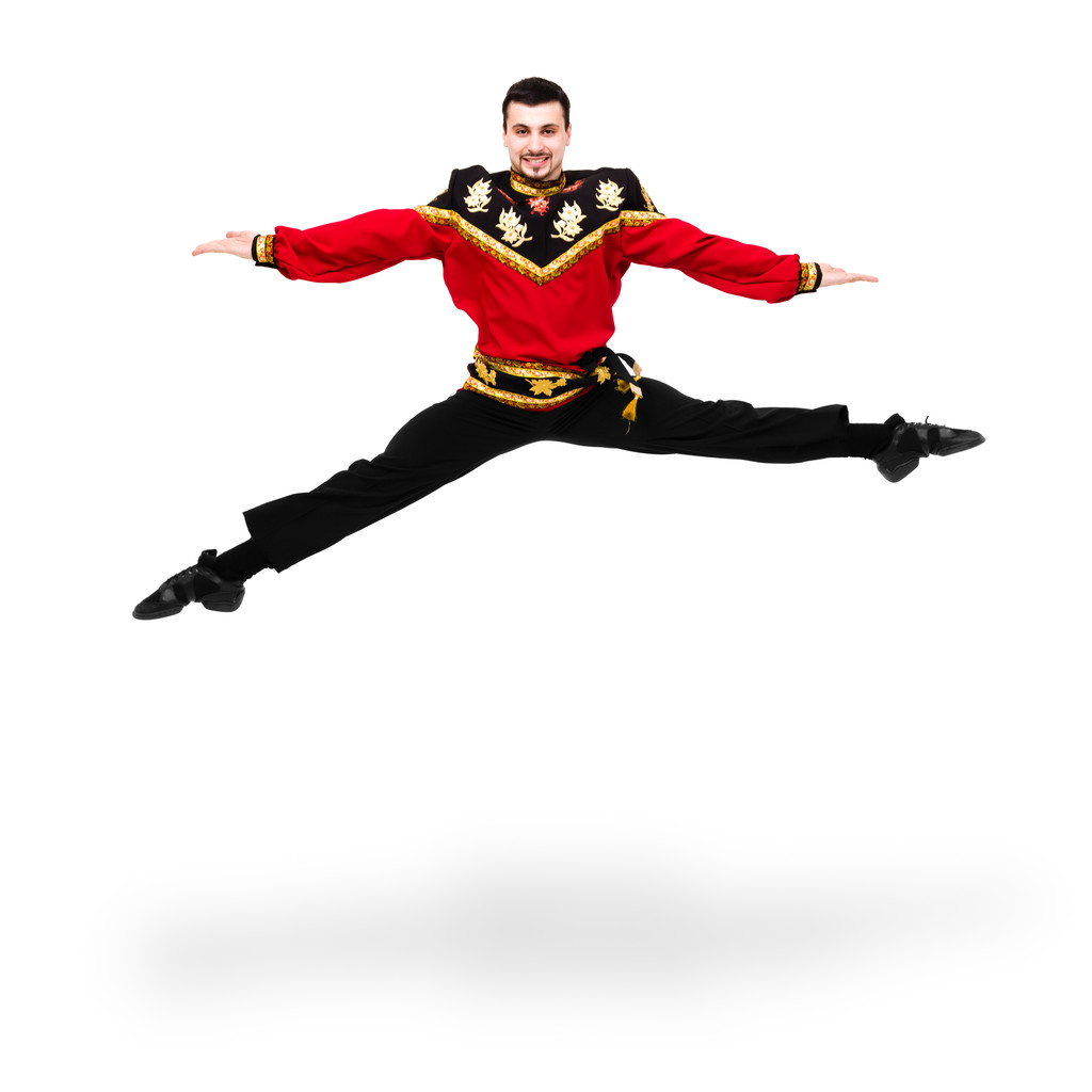 若いダンサー男ジャンプ ロシアの民族衣装を着て - 写真・画像