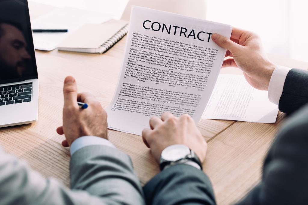 cropped image of businessman showing contract to colleague in office - Photo, Image