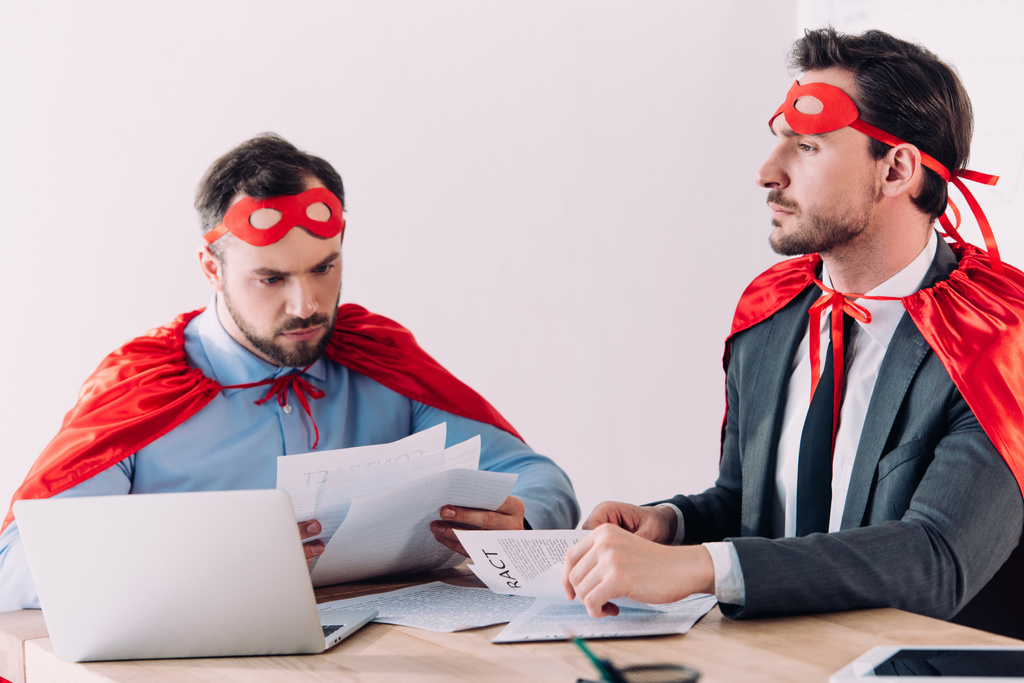 handsome super businessmen in masks and capes working with documents in office - Photo, Image