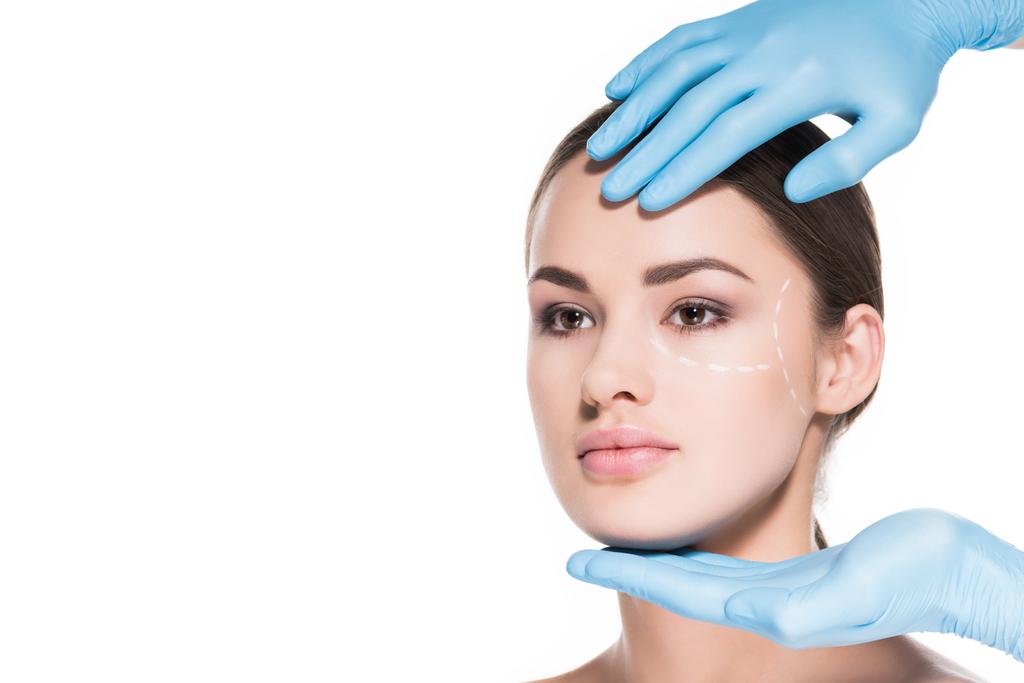doctor touching face of woman with dotted line for plastic surgery isolated on white - Photo, Image