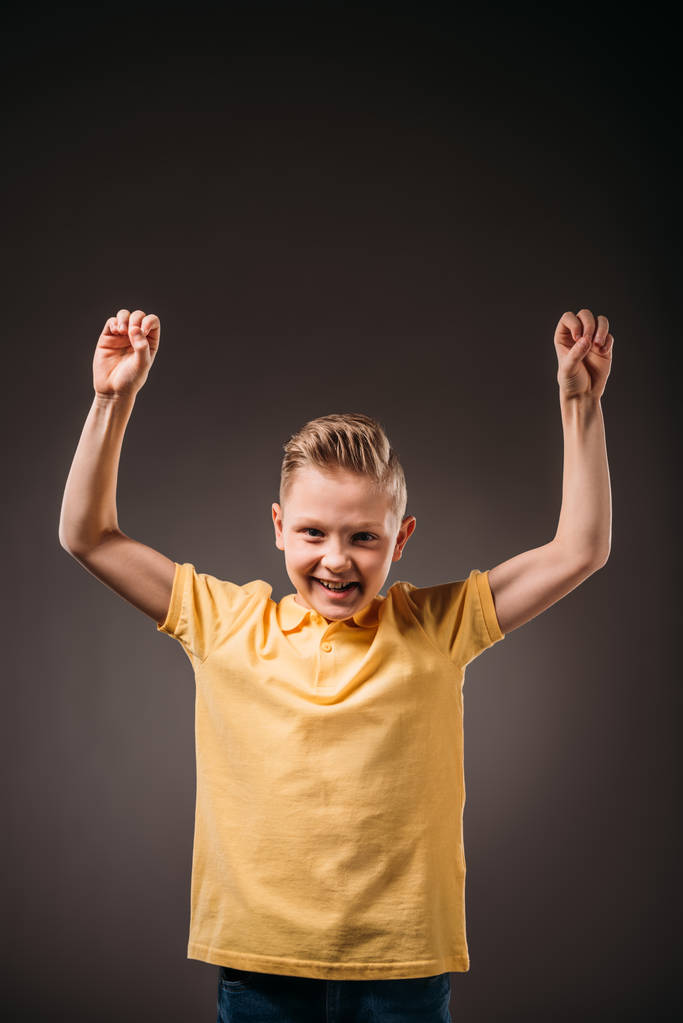 preteen smiling boy gesturing, isolated on grey - Photo, Image